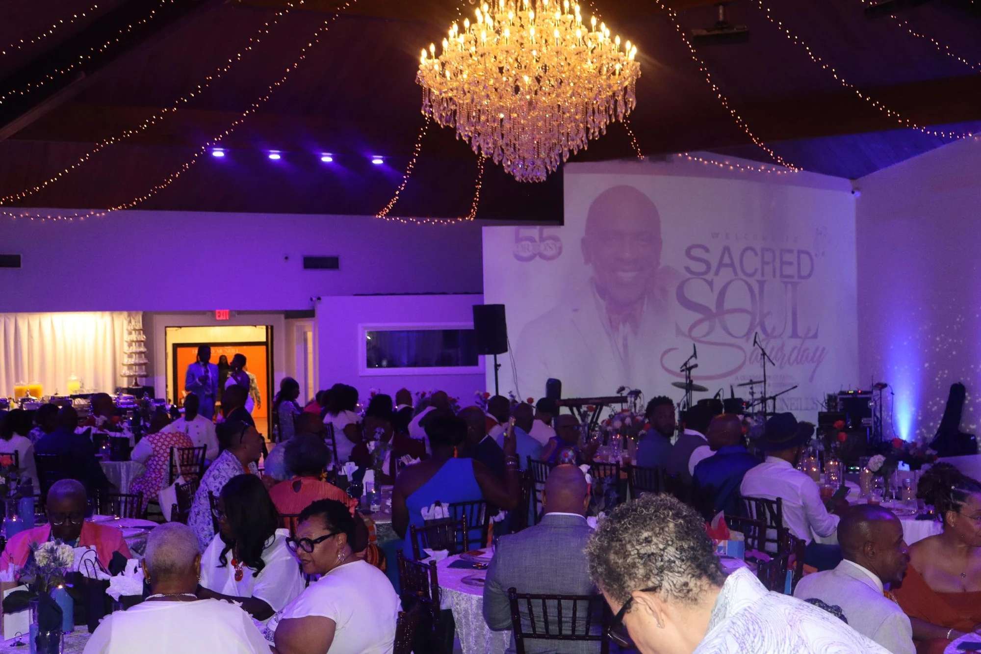 Guests gathered beneath a chandelier at Sacred Soul Saturday